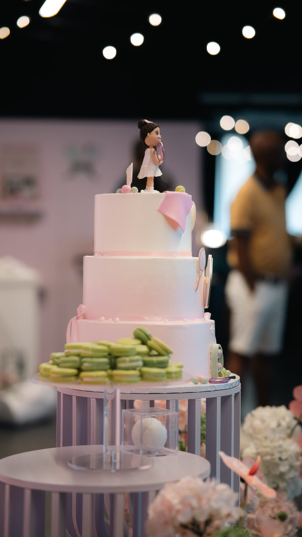 A tiered cake with macarons on a dessert display at a private celebration at Trellis 925